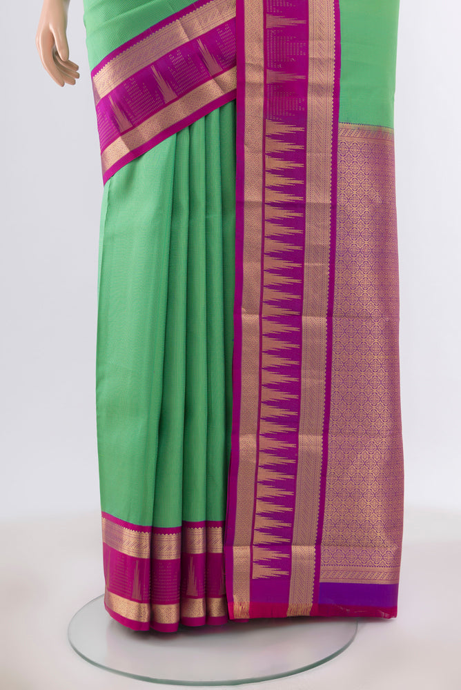 Pleats and pallu of Light Green Kanjivaram Silk Saree with Zari Butta on the body and Silk Border. 