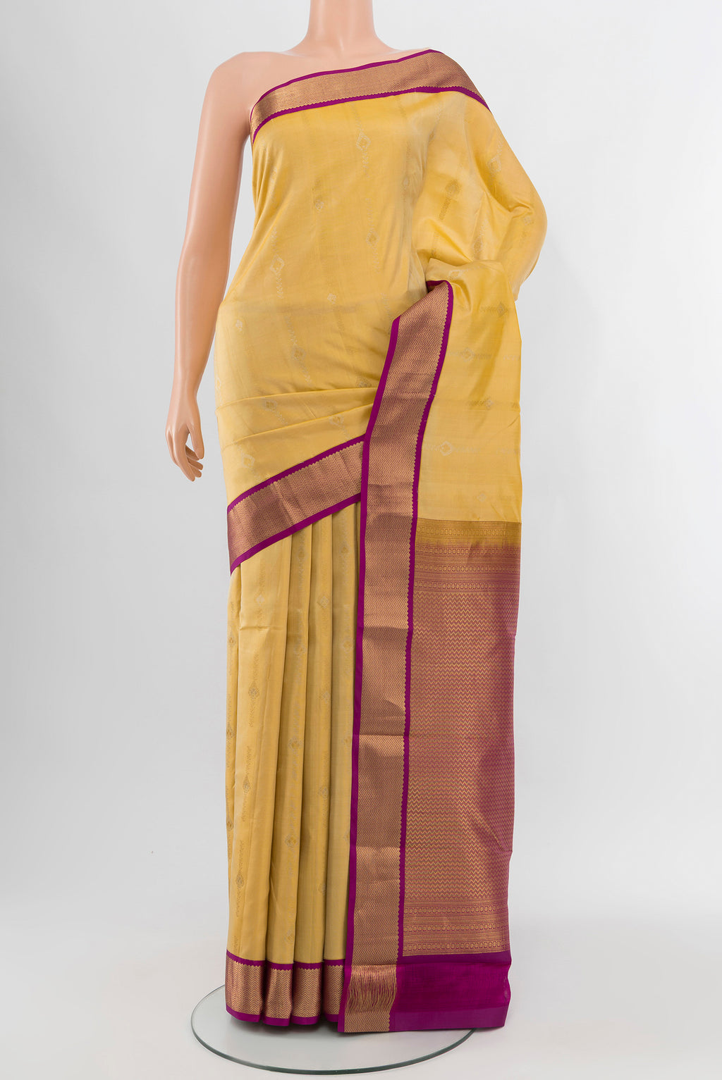Yellow Kanchipuram Silk Saree with Zari Butta on the body and Zari Border.  displayed on a mannequin