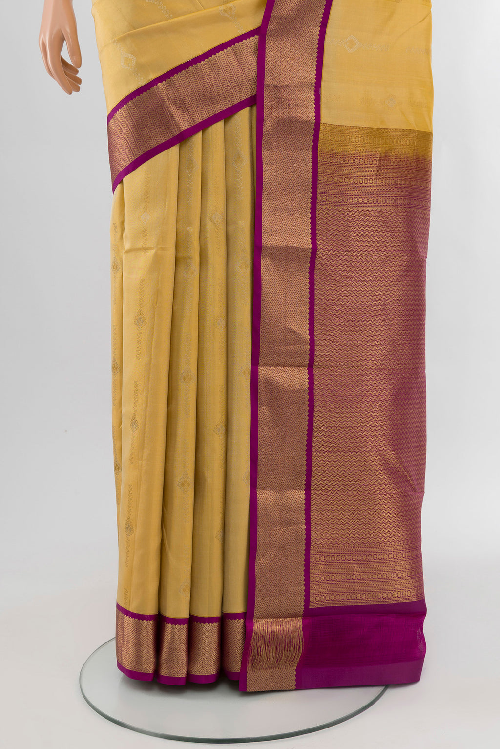 Pleats and pallu of Yellow Kanchipuram Silk Saree with Zari Butta on the body and Zari Border. 