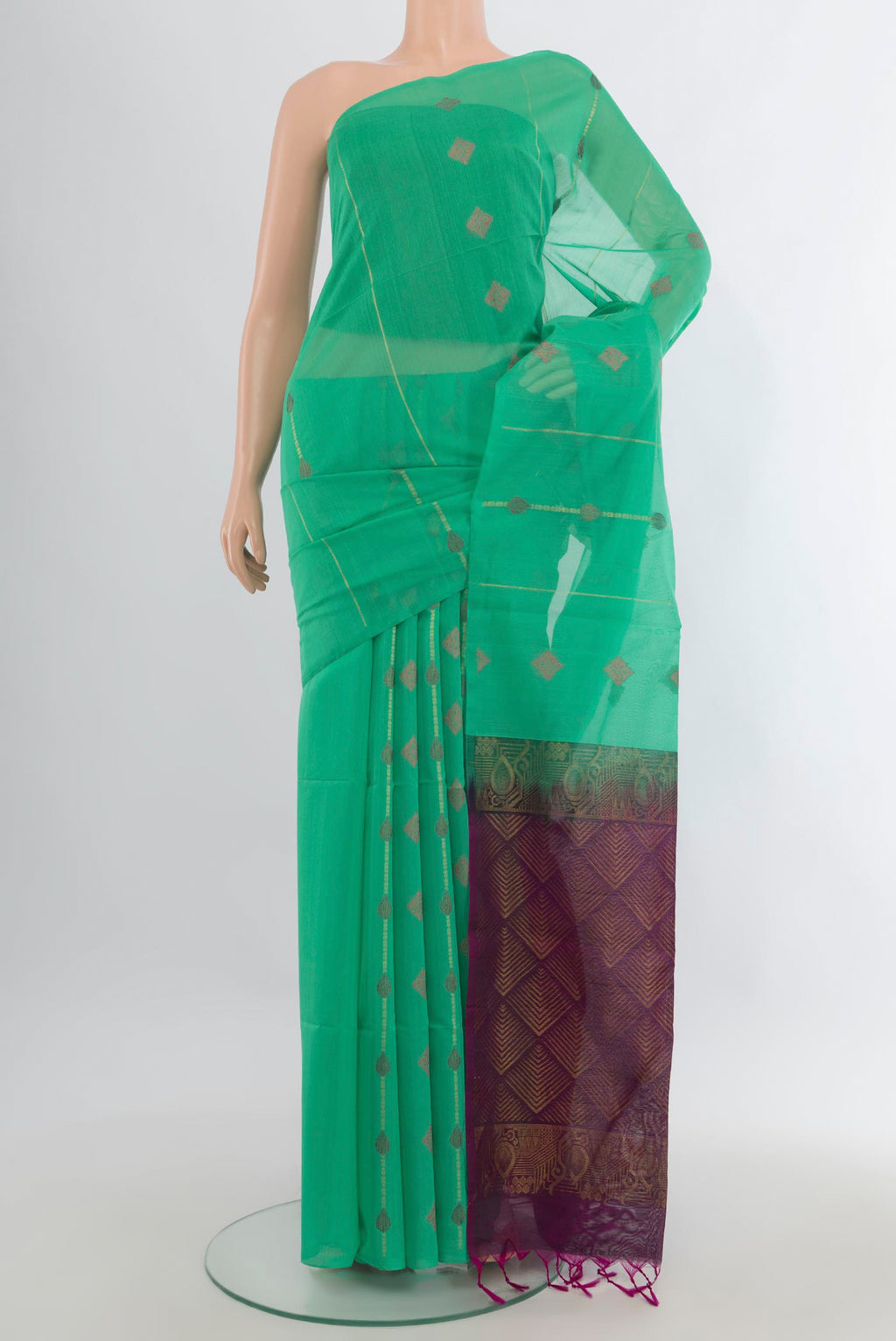 Light Green Silk Cotton Saree with Zari And Thread Butta on the body and Without Border.  displayed on a mannequin