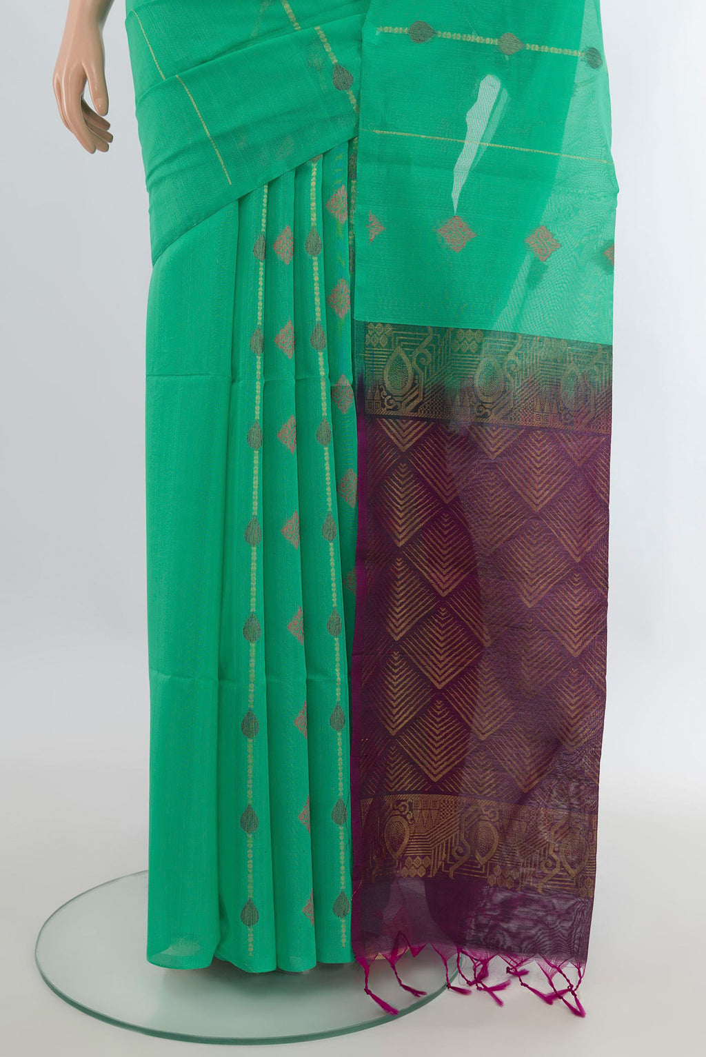 Pleats and pallu of Light Green Silk Cotton Saree with Zari And Thread Butta on the body and Without Border. 