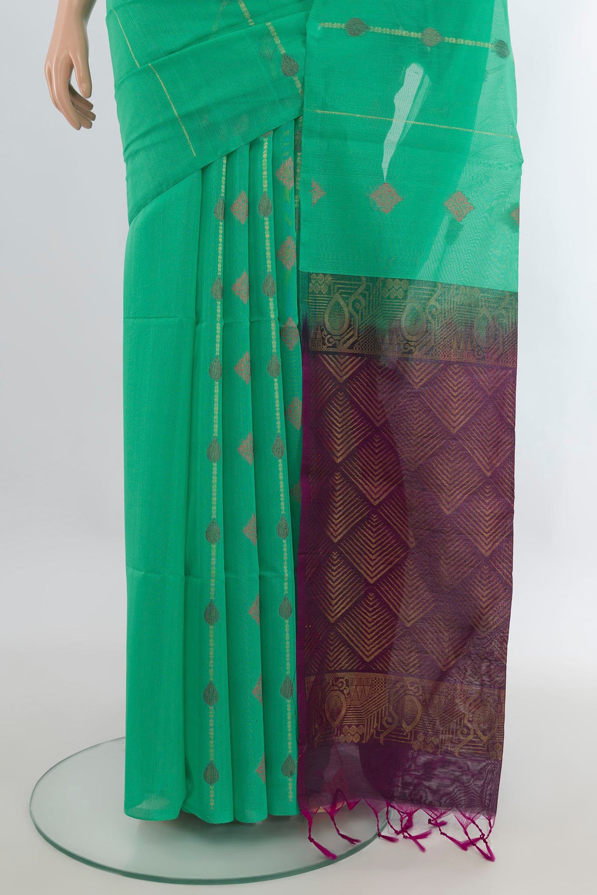 Pleats and pallu of Light Green Silk Cotton Saree with Zari And Thread Butta on the body and Without Border. 