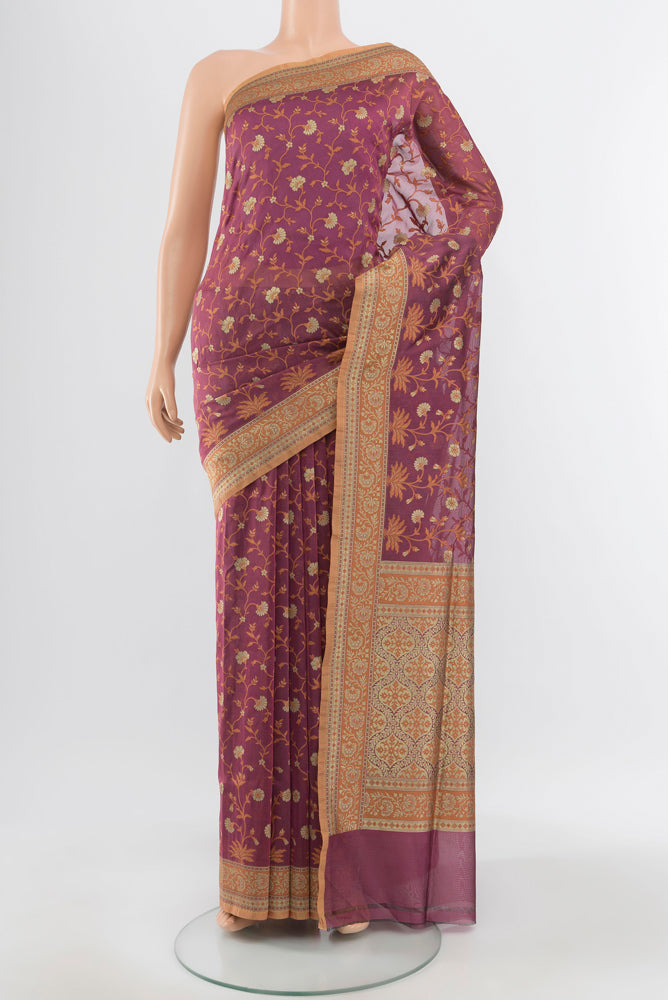 Pure Silk Pure Zari Bronze Banarasi Georgette Saree with Zari Butta on the body and Silk Border.  displayed on a mannequin