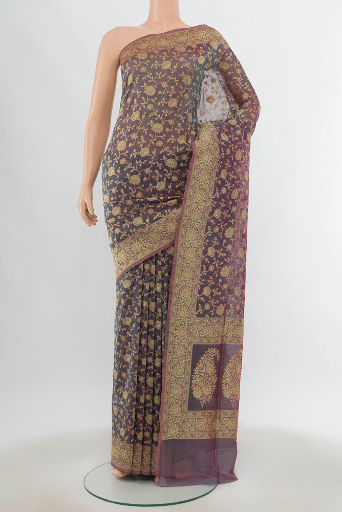 Olive Green Banarasi Georgette Saree with Zari Butta on the body and Silk Border.  displayed on a mannequin