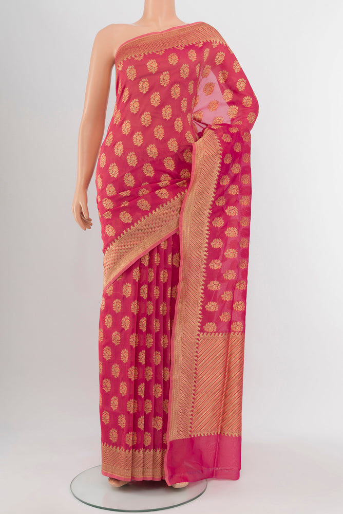 Peach Banarasi Georgette Saree with Zari Brocade on the body and Silk Border.  displayed on a mannequin