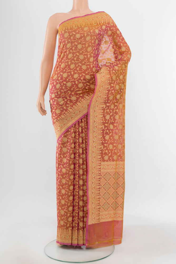 Pure Silk Pure Zari Peach Banarasi Georgette Saree with Zari Butta on the body and Silk Border.  displayed on a mannequin