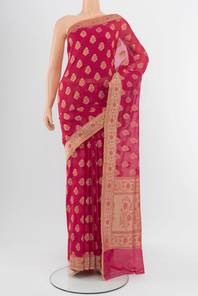 Peach Banarasi Georgette Saree with Zari Brocade on the body and Silk Border.  displayed on a mannequin
