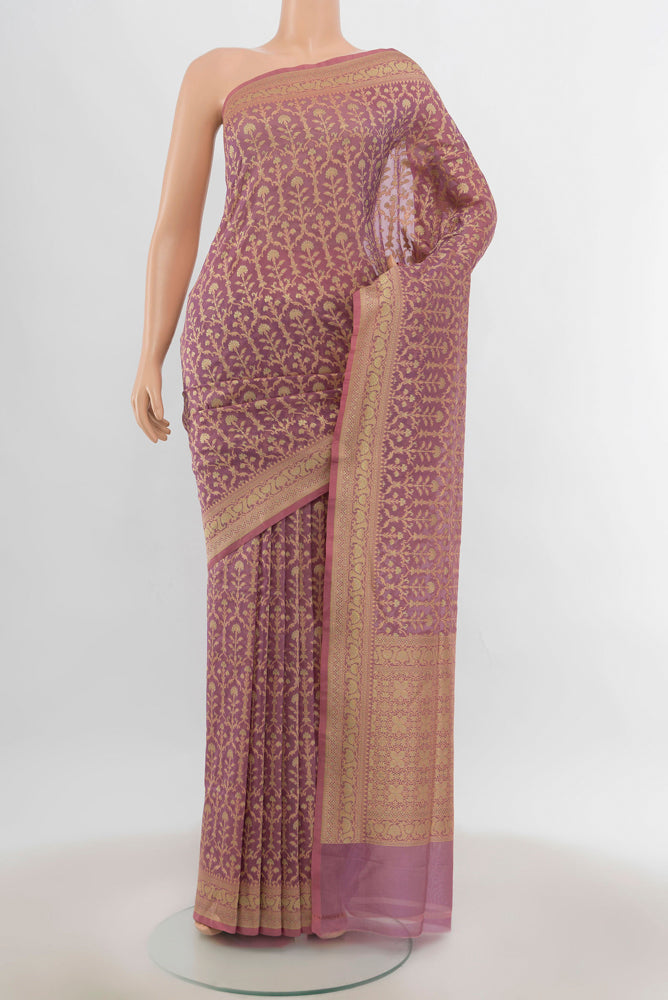 Peach Banarasi Silk Saree with Zari Butta on the body and Silk Border.  displayed on a mannequin