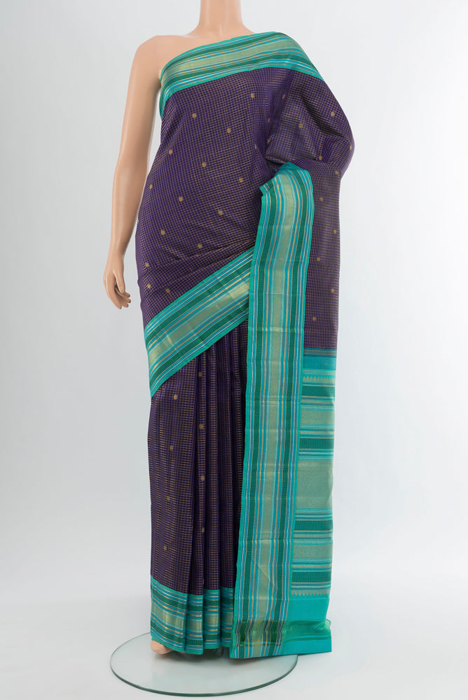 Pure Silk Pure Zari Navy Blue Kanchipuram Saree with Zari Butta on the body and Silk Border.  displayed on a mannequin