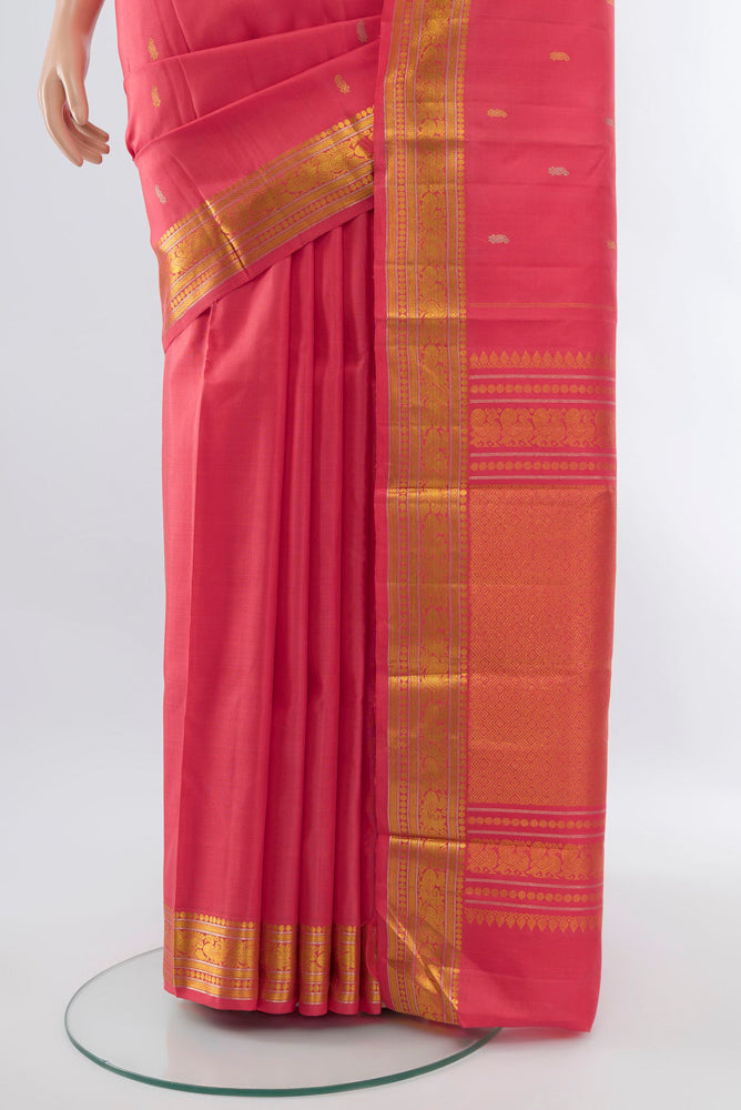 Pleats and pallu of Rose pink Kanchipuram Silk Saree with Zari Butta on the body and Silk Border. 