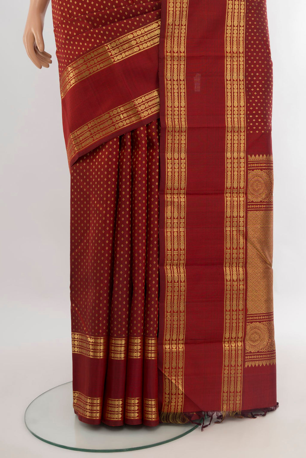 Pleats and pallu of Maroon Kanjivaram Silk Saree with Zari Butta on the body and Zari Border. 