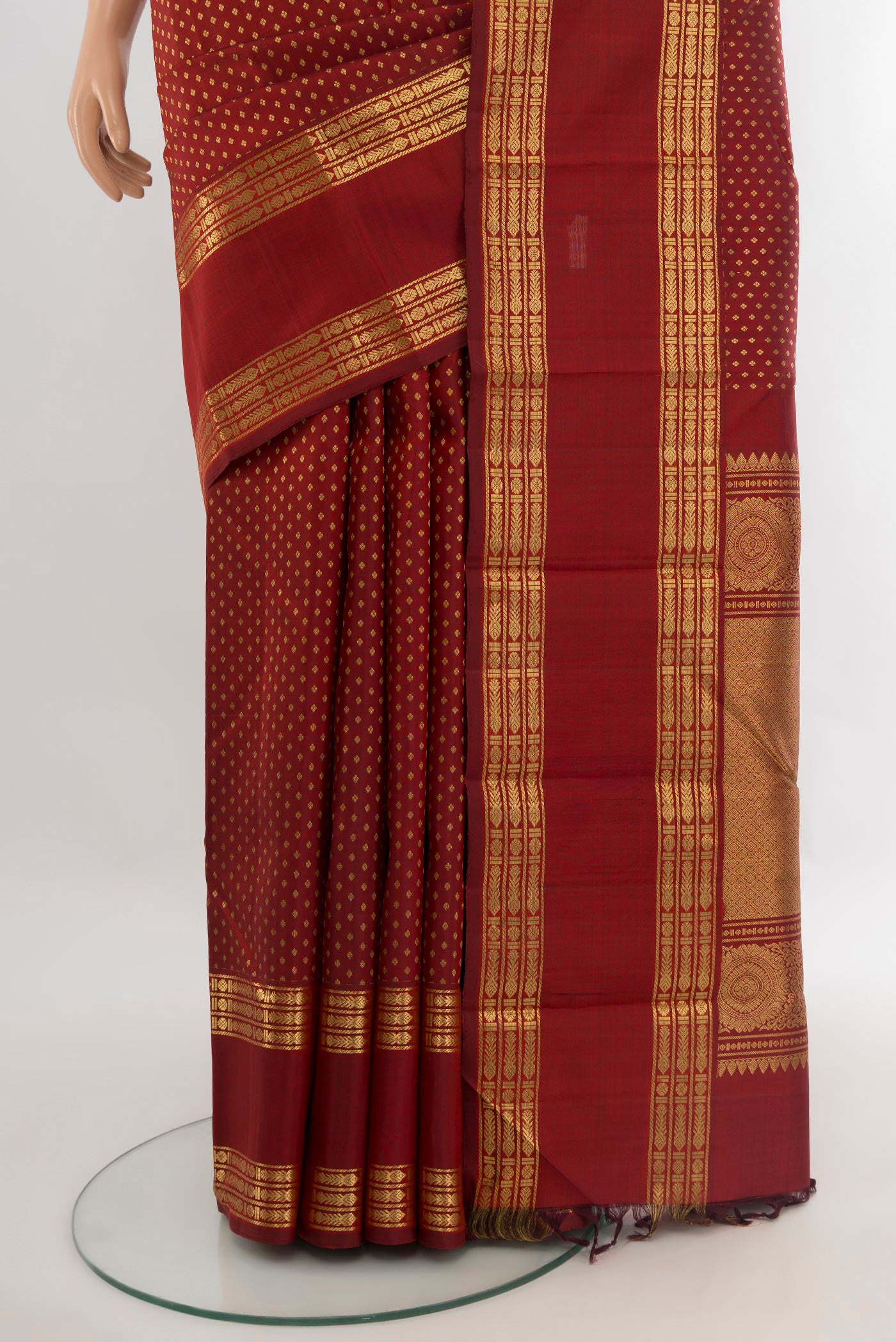 Pleats and pallu of Maroon Kanjivaram Silk Saree with Zari Butta on the body and Zari Border. 