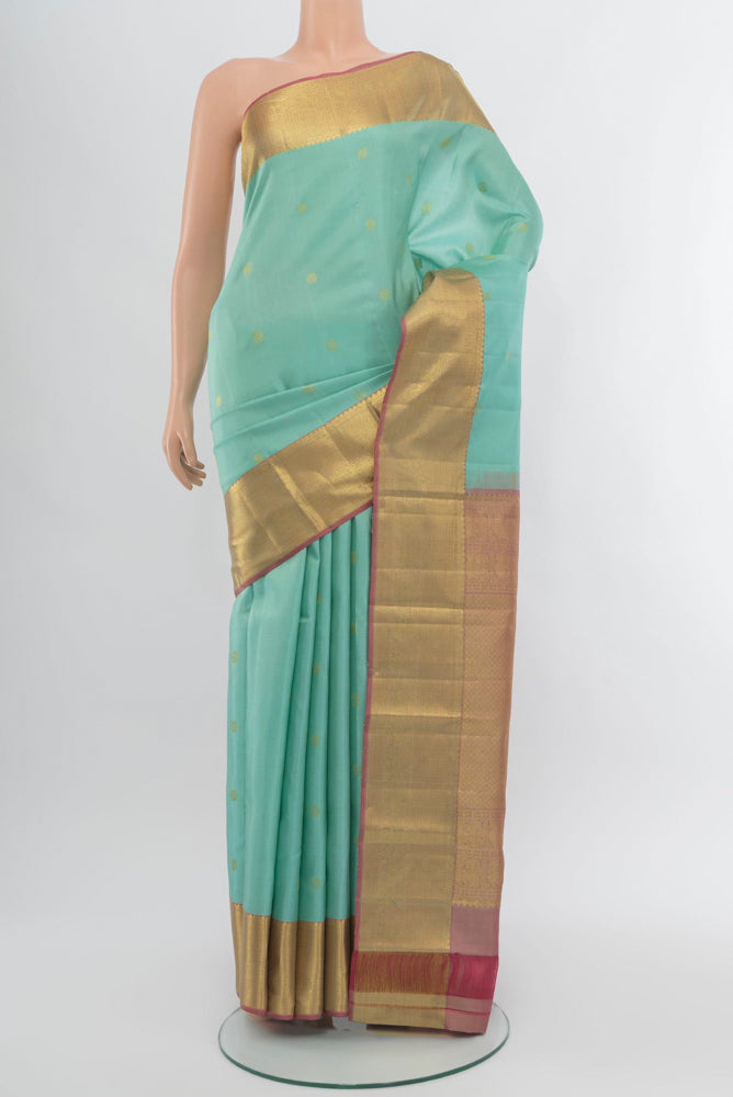 Sky Blue Kanchipuram Silk Saree with Zari Butta on the body and Silk Border.  displayed on a mannequin