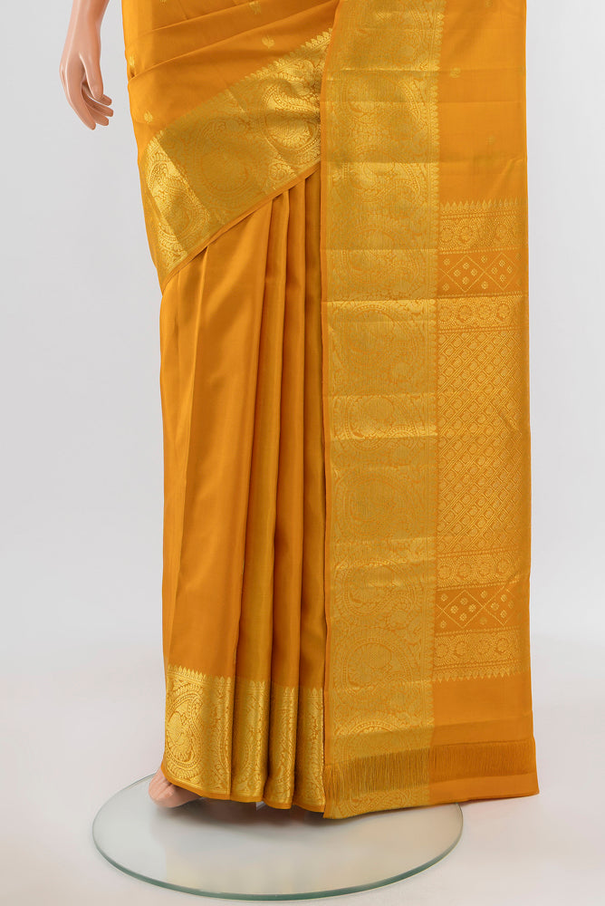 Pleats and pallu of Pure Silk Pure Zari Mustard Kanchipuram Saree with Zari Butta on the body and Silk Border. 
