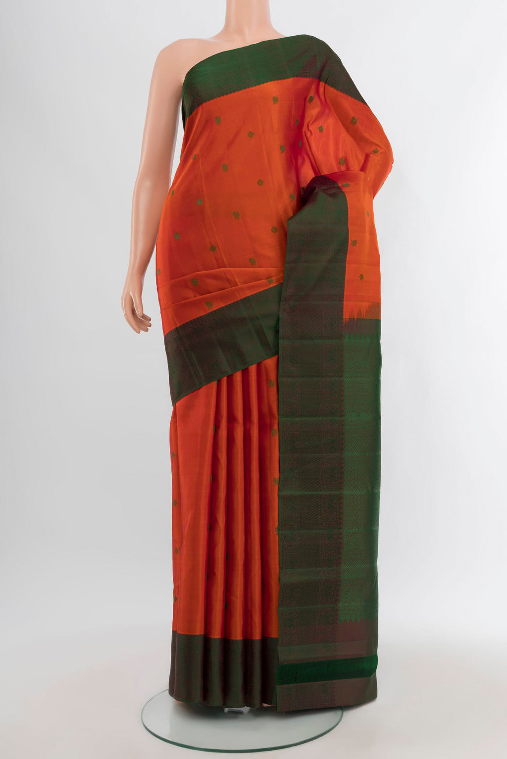 Brick Orange Kanchipuram Silk Saree with Thread Butta on the body and Thread Border.  displayed on a mannequin