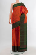 Brick Orange Kanchipuram Silk Saree with Thread Butta on the body and Thread Border.  displayed on a mannequin