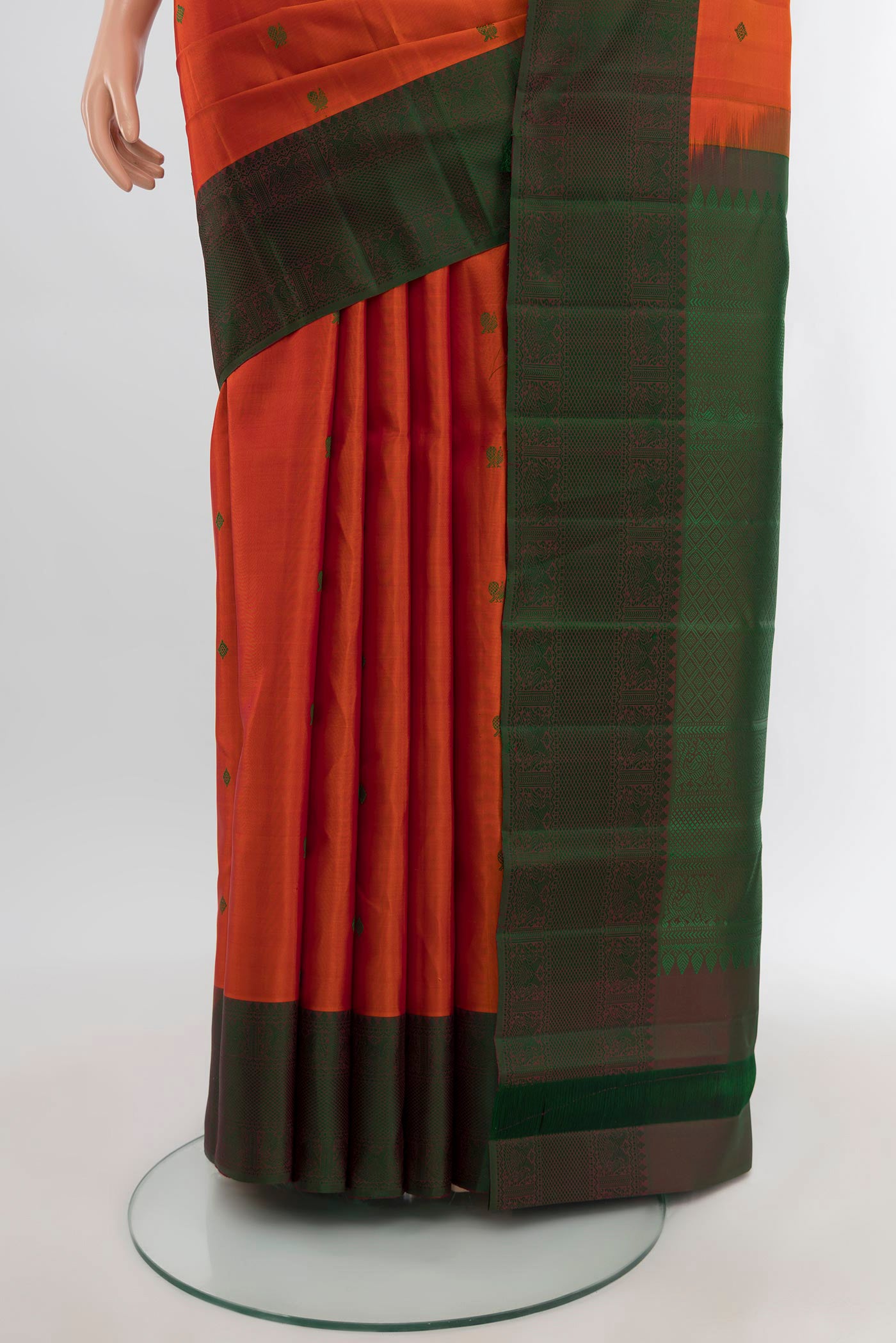 Pleats and pallu of Brick Orange Kanchipuram Silk Saree with Thread Butta on the body and Thread Border. 