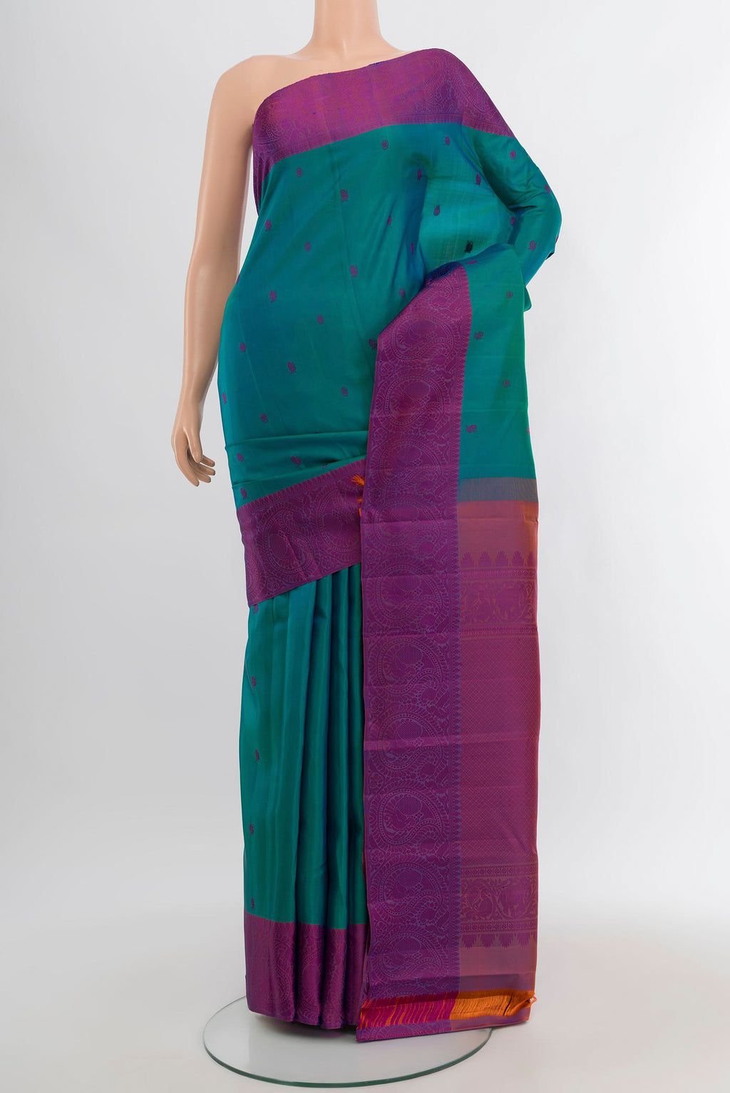 Peacock Blue Kanchipuram Silk Saree with Thread Butta on the body and Thread Border.  displayed on a mannequin