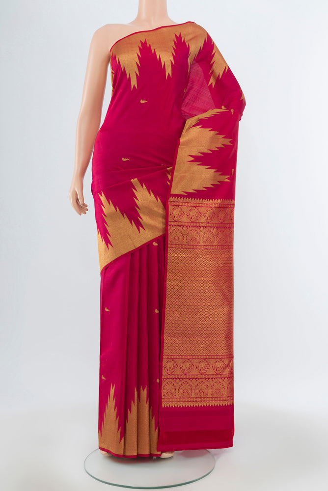 Maroon Kanjivaram Silk Saree with Zari Butta on the body and Silk Border.  displayed on a mannequin