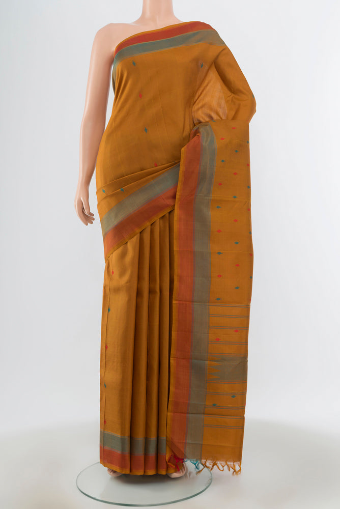 Brown Kanchipuram Silk Saree with Zari Butta on the body and Silk Border.  displayed on a mannequin