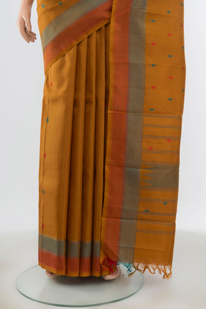 Pleats and pallu of Brown Kanchipuram Silk Saree with Zari Butta on the body and Silk Border. 