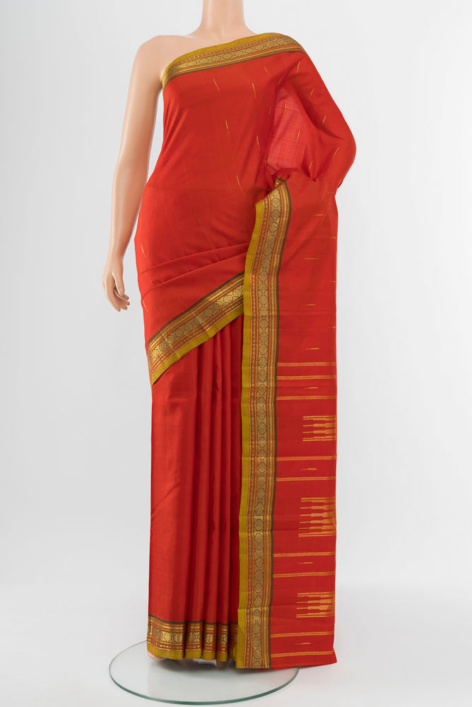 Red Kanchipuram Silk Saree with Zari Butta on the body and Silk Border.  displayed on a mannequin