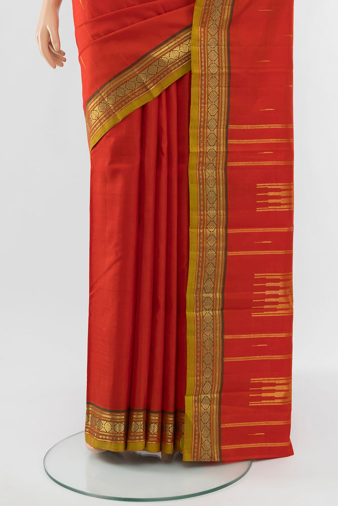 Pleats and pallu of Red Kanchipuram Silk Saree with Zari Butta on the body and Silk Border. 