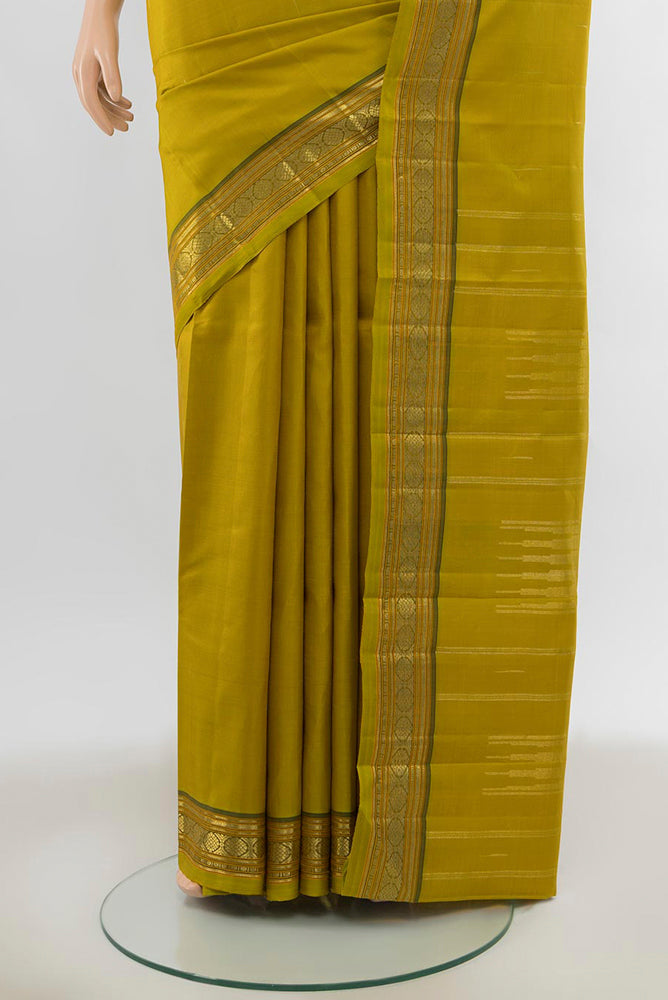 Pleats and pallu of Pure Silk Pure Zari Mehandi Green Kanchipuram Saree with Zari Butta on the body and Silk Border. 
