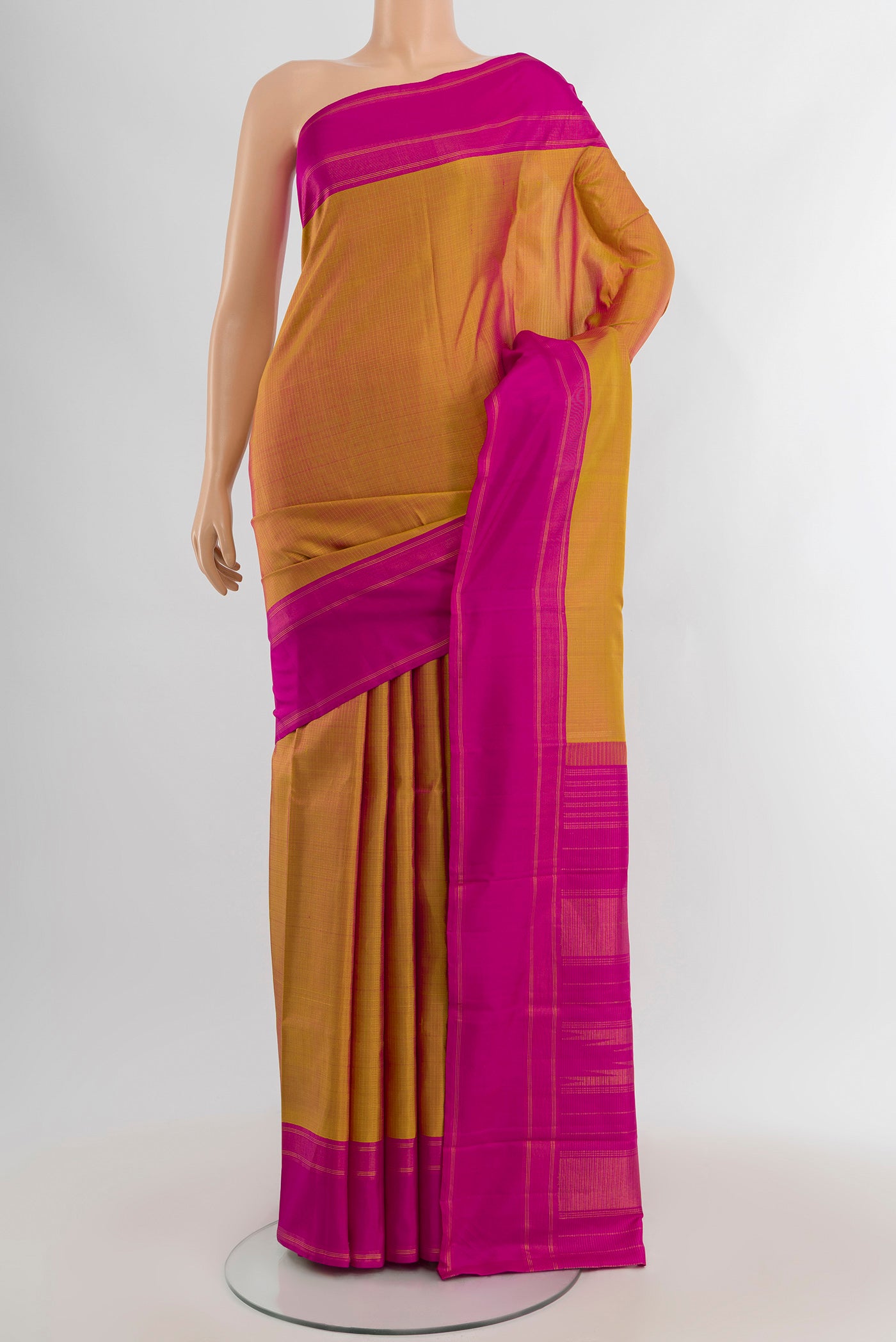 Mustard Kanchipuram Silk Saree with Checked design on the body and Plain Border.  displayed on a mannequin