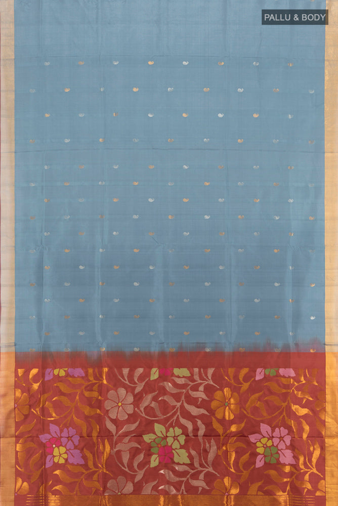 Flat view of Grey Uppada Silk Saree with Zari Butta on the body and Silk Border. 