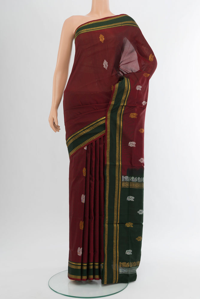 Pure Silk Pure Zari Maroon Uppada Saree with Zari Butta on the body and Silk Border.  displayed on a mannequin