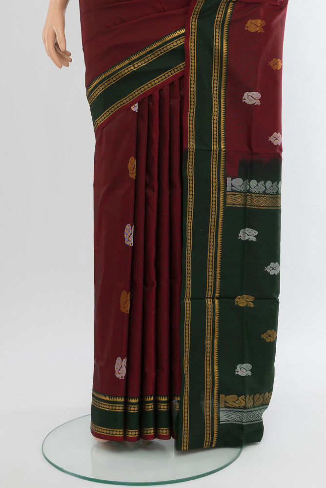 Pleats and pallu of Pure Silk Pure Zari Maroon Uppada Saree with Zari Butta on the body and Silk Border. 