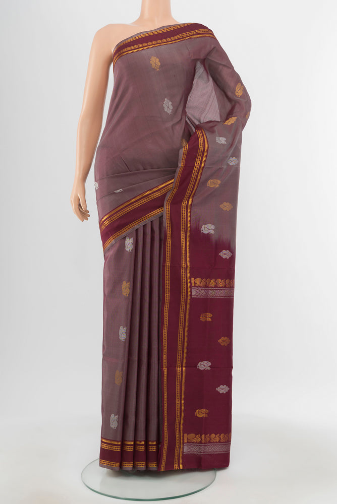 Brown Uppada Silk Saree with Zari Butta on the body and Silk Border.  displayed on a mannequin