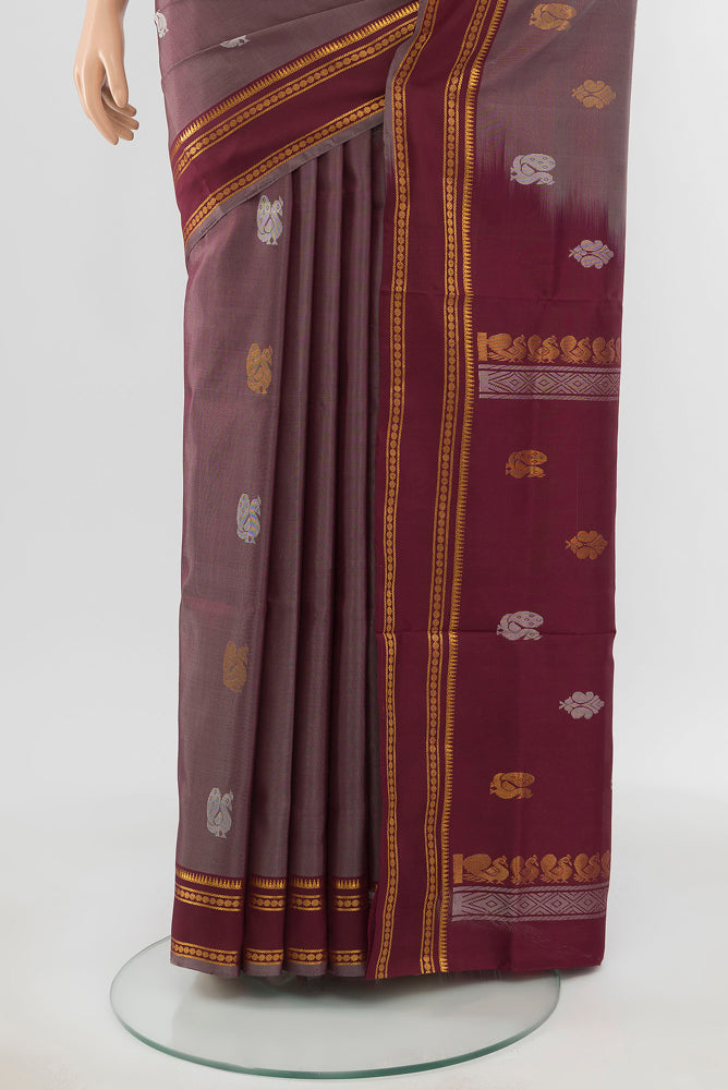 Pleats and pallu of Brown Uppada Silk Saree with Zari Butta on the body and Silk Border. 