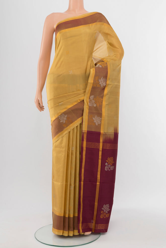 Beige Uppada Silk Saree with Zari Butta on the body and Silk Border.  displayed on a mannequin