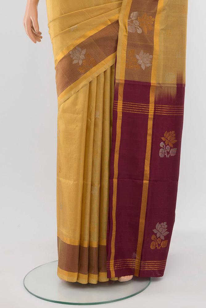 Pleats and pallu of Beige Uppada Silk Saree with Zari Butta on the body and Silk Border. 