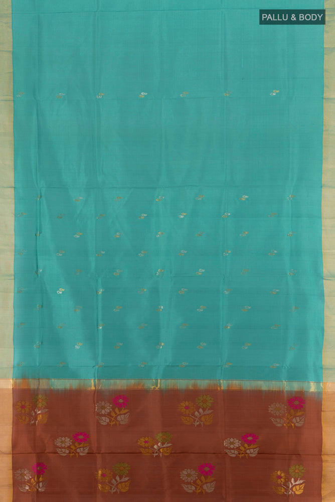 Flat view of Blue Grey Uppada Silk Saree with Zari Butta on the body and Silk Border. 
