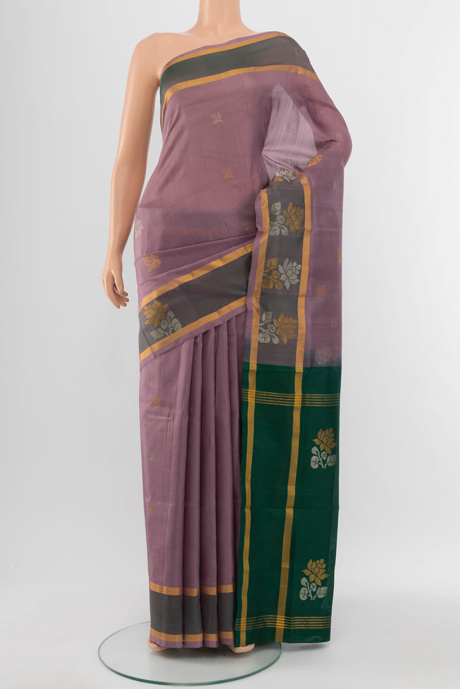 Bronze Uppada Silk Saree with Zari Butta on the body and Silk Border.  displayed on a mannequin