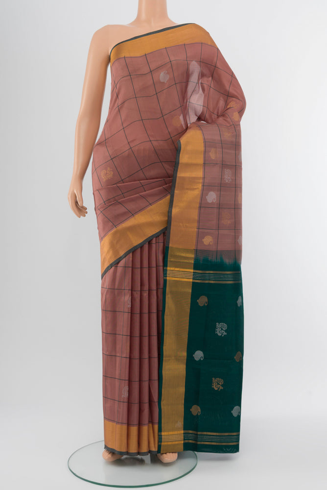 Bronze Uppada Silk Saree with Zari Butta on the body and Silk Border.  displayed on a mannequin