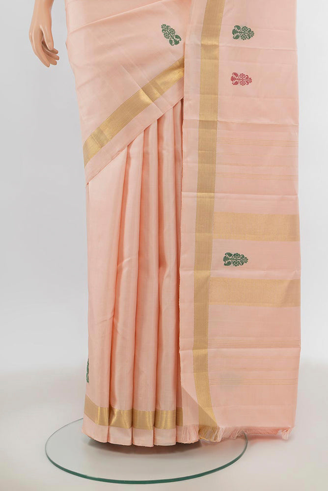 Pleats and pallu of Rose Gold Kanchipuram Silk Saree with Zari Butta on the body and Silk Border. 