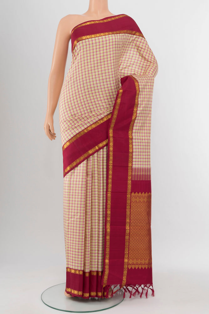 Multi Color Kanjivaram Silk Saree with Zari Butta on the body and Silk Border.  displayed on a mannequin