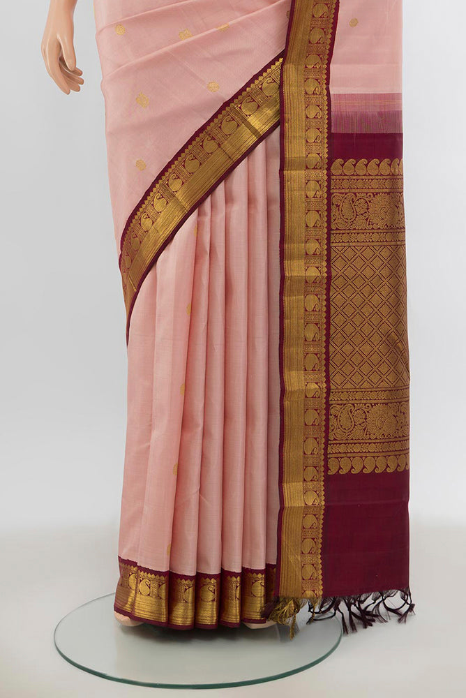 Pleats and pallu of Pure Silk Pure Zari Rose Gold Kanjivaram Saree with Zari Butta on the body and Silk Border. 