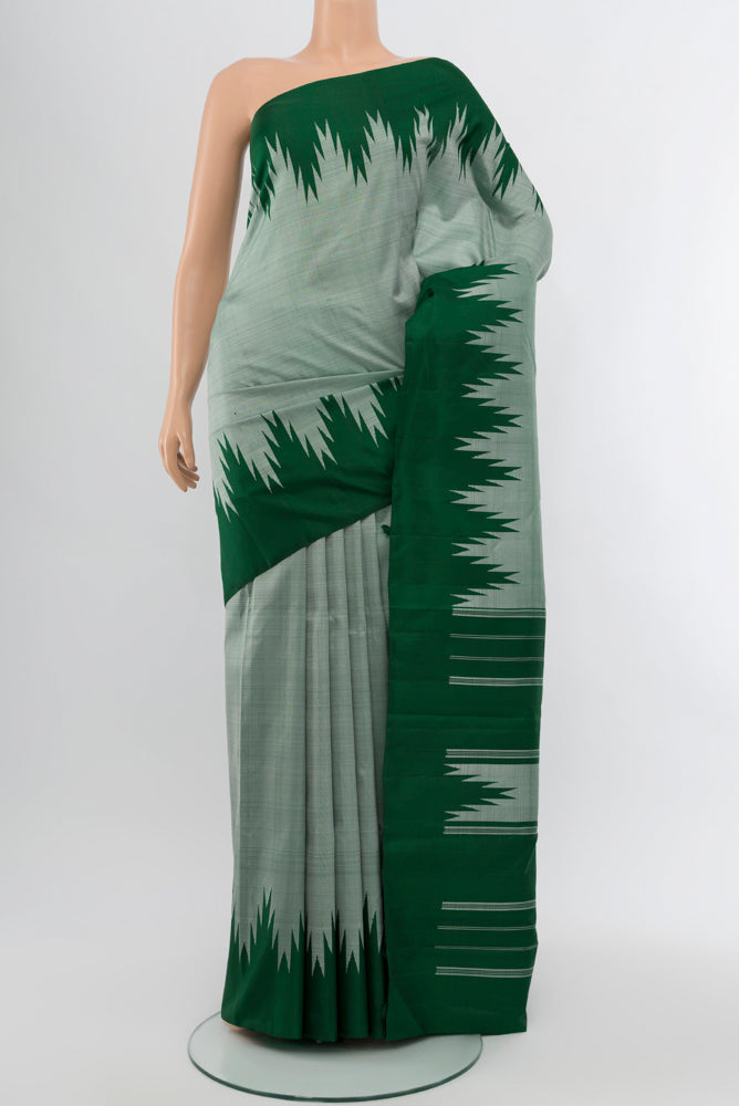 Light Green Kanjivaram Silk Saree with Zari Butta on the body and Silk Border.  displayed on a mannequin