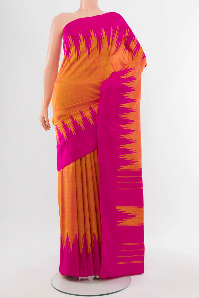 Pure Silk Pure Zari Peach Kanjivaram Saree with Zari Butta on the body and Silk Border.  displayed on a mannequin