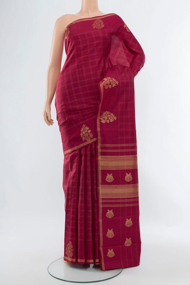 Maroon Kanjivaram Silk Saree with Zari Butta on the body and Silk Border.  displayed on a mannequin