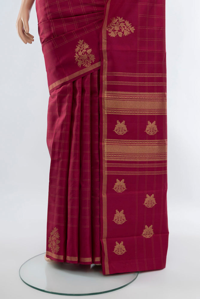 Pleats and pallu of Maroon Kanjivaram Silk Saree with Zari Butta on the body and Silk Border. 