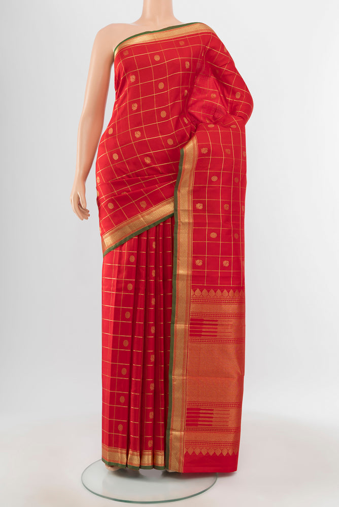 Pure Silk Pure Zari Red Kanjivaram Saree with Zari Butta on the body and Silk Border.  displayed on a mannequin