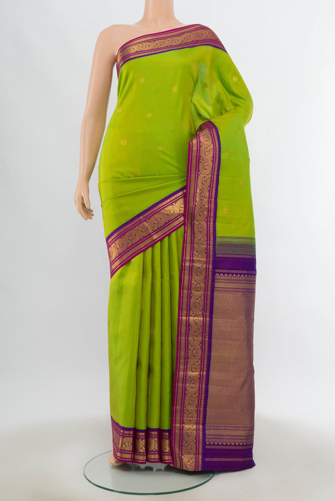 Pure Silk Pure Zari Parrot Green Kanjivaram Saree with Zari Butta on the body and Silk Border.  displayed on a mannequin