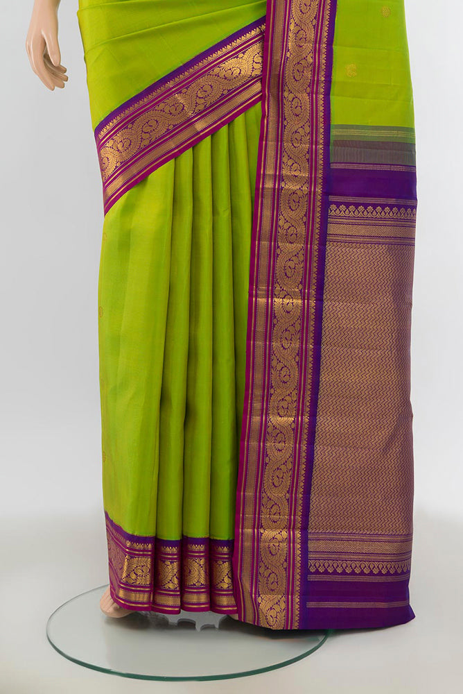 Pleats and pallu of Pure Silk Pure Zari Parrot Green Kanjivaram Saree with Zari Butta on the body and Silk Border. 