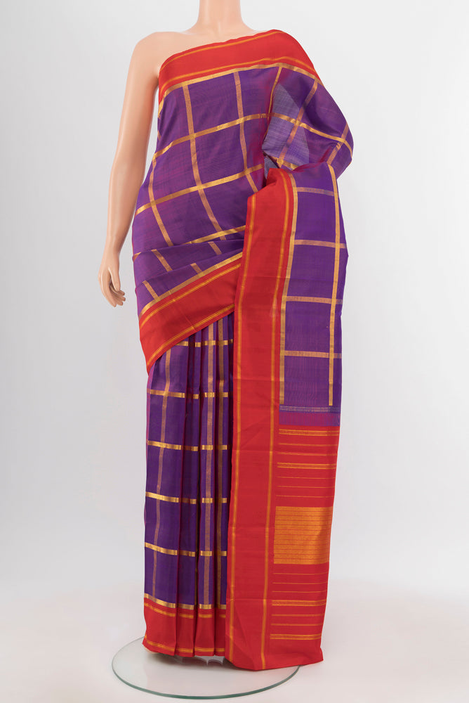 Magenta Kanchipuram Silk Saree with Zari Butta on the body and Silk Border.  displayed on a mannequin